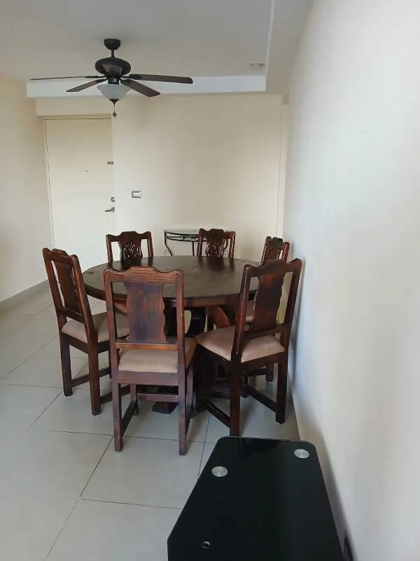 Dining area with round wooden table six chairs ceiling fan PH Condado Country Club Condado del Rey Panama