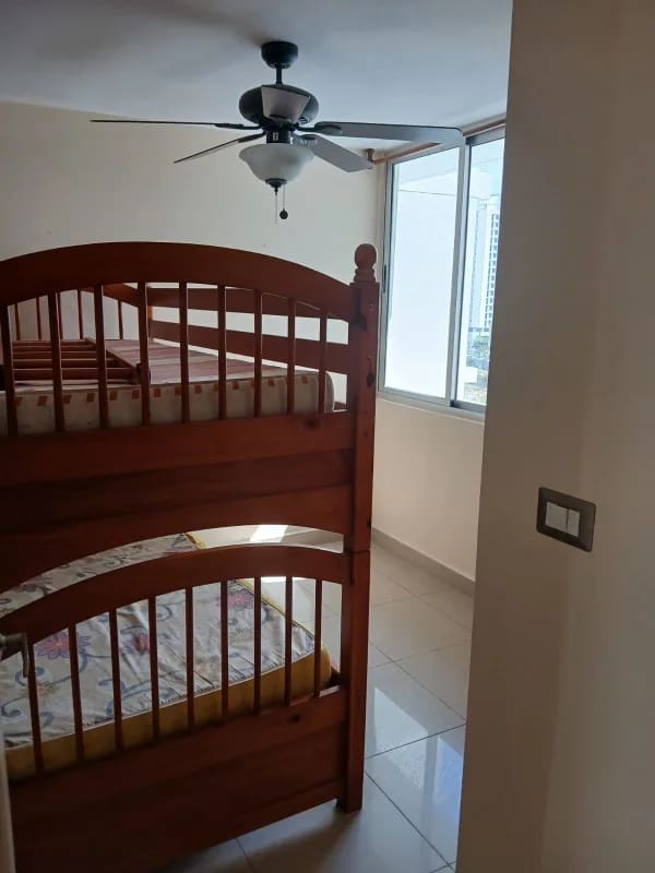 Bedroom with large window, built-in wooden wardrobe, tile floor PH Condado Country Club Panama furnished apartment