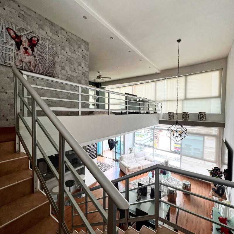 Large balcony with glass rails overlooking skyline and water at Bayfront Tower Panama City