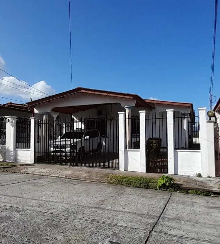 Side walkway and rear yard view of fenced rental house Brisas del Golf Panama