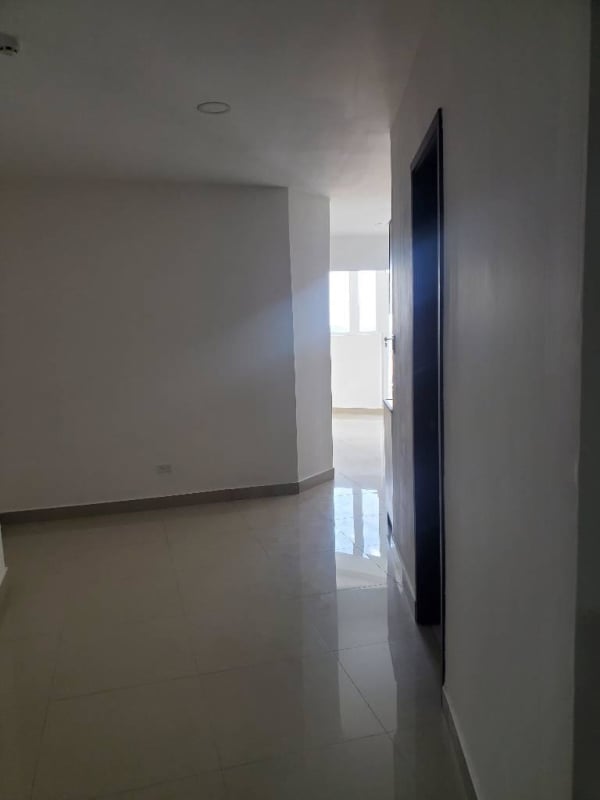 Minimalist hallway with glossy tile floors and white walls Bay View Condo Panama City for rent