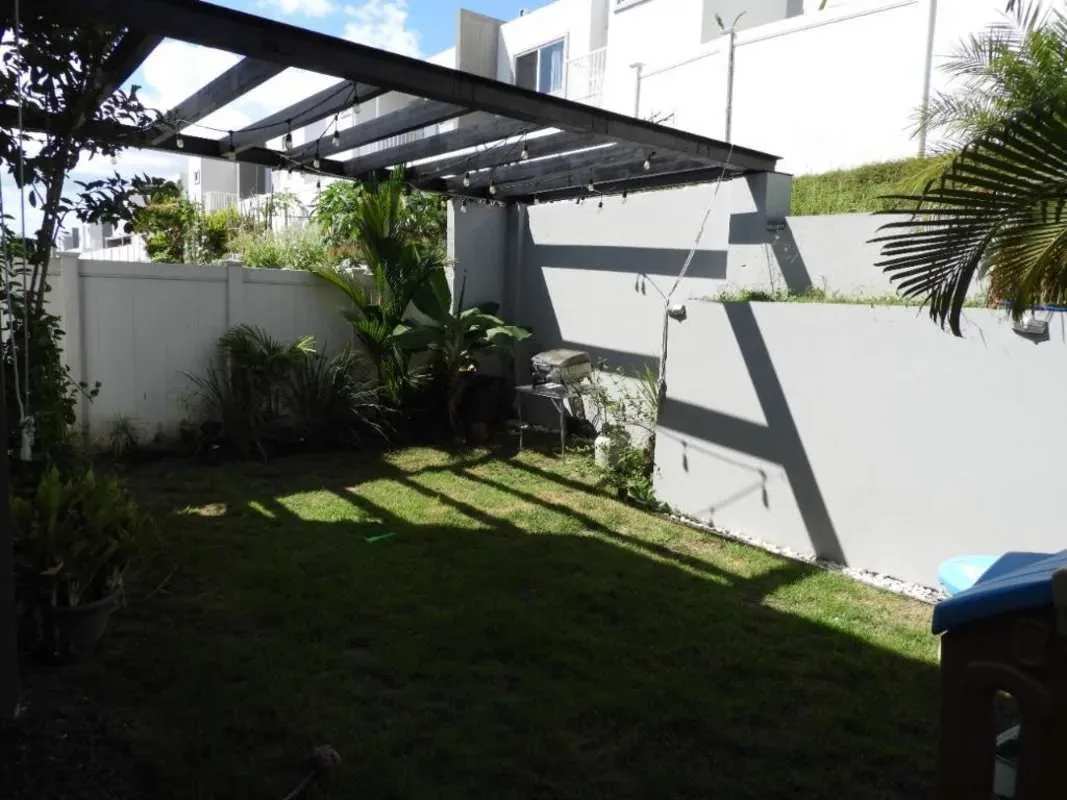 Outdoor terrace with pergola, garden, grill and string lights in PH Victoria Brisas del Golf Panama