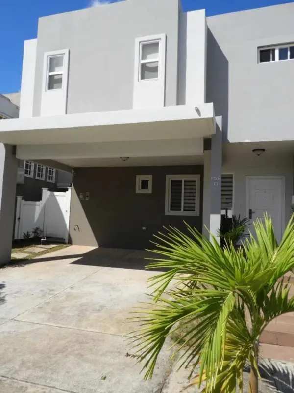 Bright staircase with decorative windows, chandelier, and metal railing in PH Victoria Brisas del Golf Panama