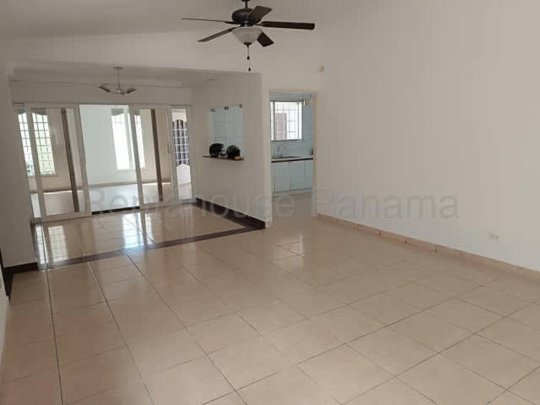 Open dining and living room with tiled floor and large windows Brisas del Golf house Panama for sale