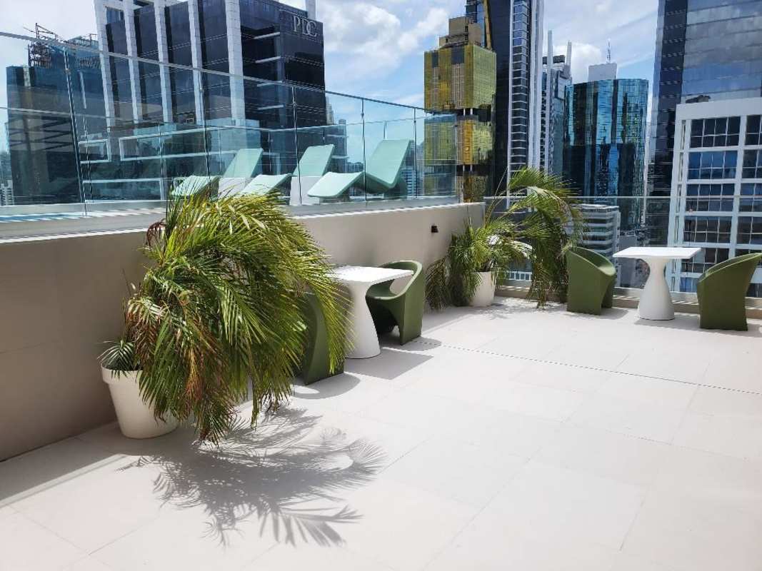 Modern kitchenette with granite counters and dark cabinetry PH Mini Design House Panama City