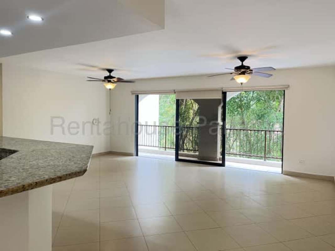Living room with large sliding doors leading to balcony in Embassy Club Clayton Panama