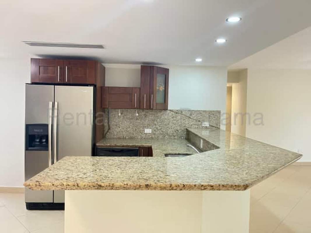 Kitchen with granite countertops, wood cabinets and appliances at Embassy Club Clayton Panama