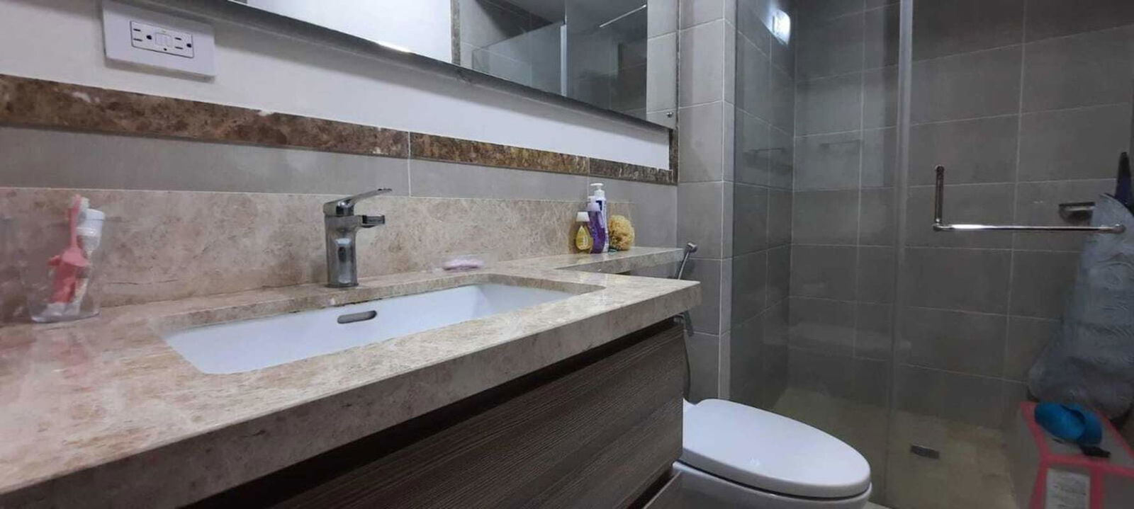 Modern marble bathroom with large mirror and glass shower Santa Maria Panama apartment