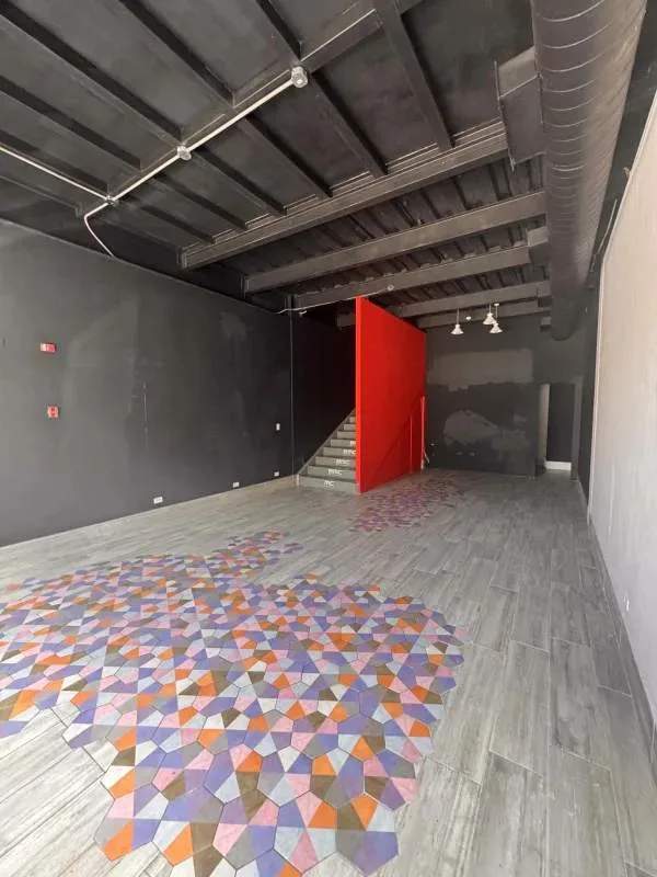 Industrial interiors with mosaic tile floor, exposed ceiling, staircase at Plaza SF69 commercial unit Panama City