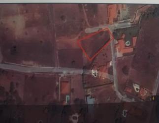 Vacant flat land with greenery and neighborhood nearby in Nueva Gorgona beach area