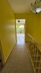 Bright open-plan kitchen with granite countertop and yellow walls at Malibu Beach Playa Malibú