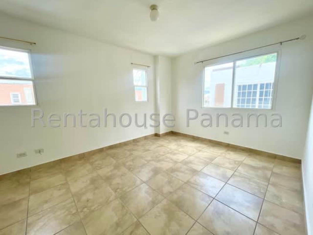 Spacious living room with ceramic tiles, white walls, large windows in PH Everest Paseo del Norte