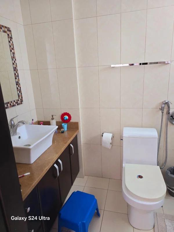 Spacious master bedroom with ensuite bath and balcony access overlooking the city and ocean at PH Titanium Costa del Este