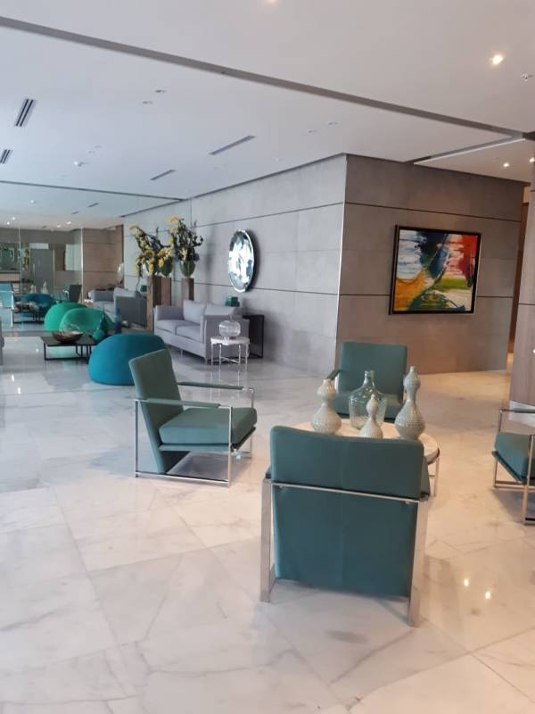 Lobby lounge area with contemporary teal armchairs, art decor in PH Sky Point Panama