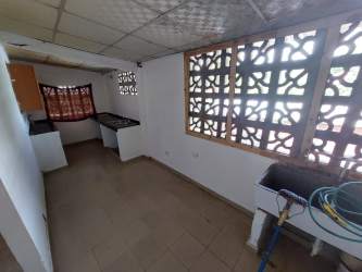 Simple bathroom tiled walls and walk-in shower in Burunga affordable house Panama