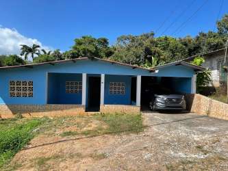 Single story blue home with carport and garden affordable property Burunga Panama Oeste