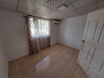Bedroom with curtains, tiled floor, AC connection Burunga affordable house Panama