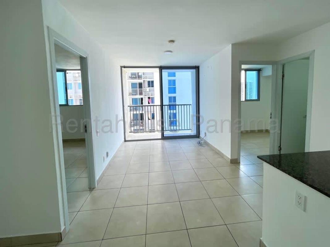 Apartment kitchen with granite countertop, white cabinets, tiled backsplash in PH Alai Panama City