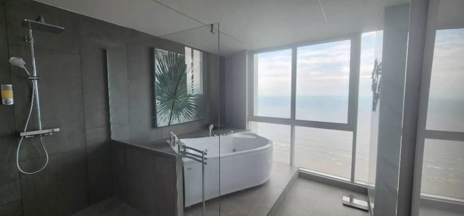Spa-style bathroom with marble finishes, freestanding tub with panoramic ocean view in The Regent Costa del Este Panama