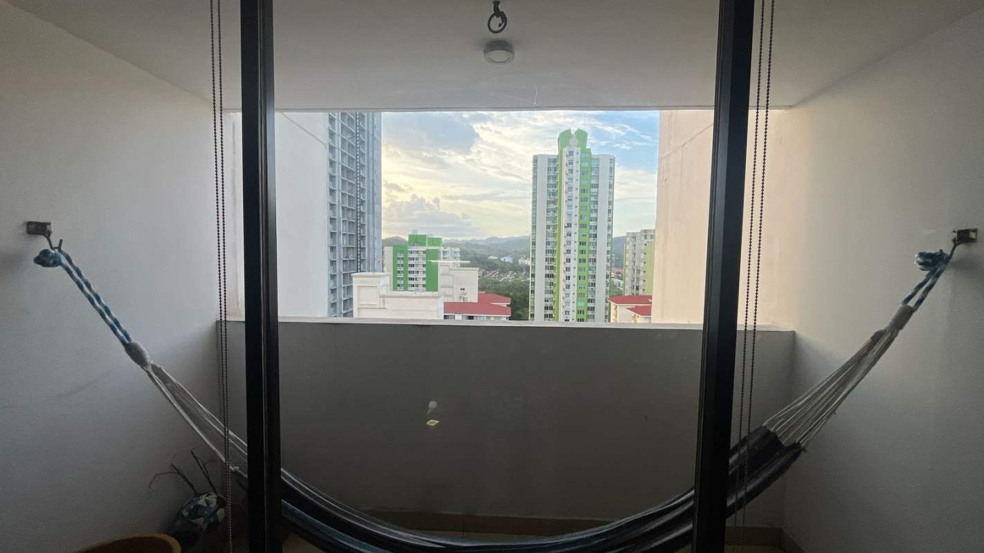 Modern kitchen with refrigerator, stove, cabinets, and laundry area in apartment Panama City