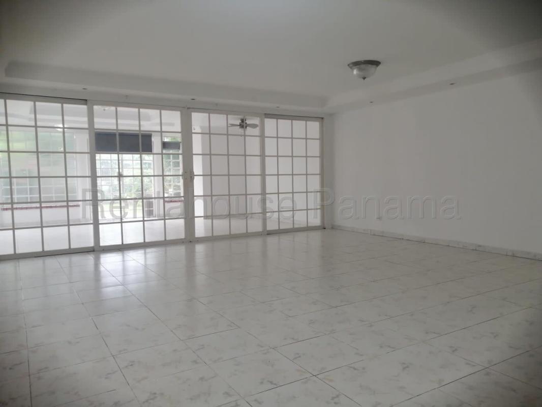 Living room with large sliding glass doors tiled floor Betania Panama home