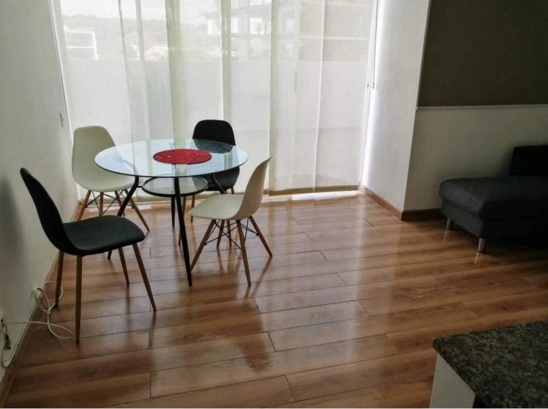 Modern dining table and living space with window, bright and open in Alsacia Towers
