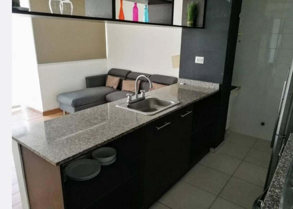 Kitchen with granite countertops, appliances, modern cabinetry in Alsacia Towers Panama