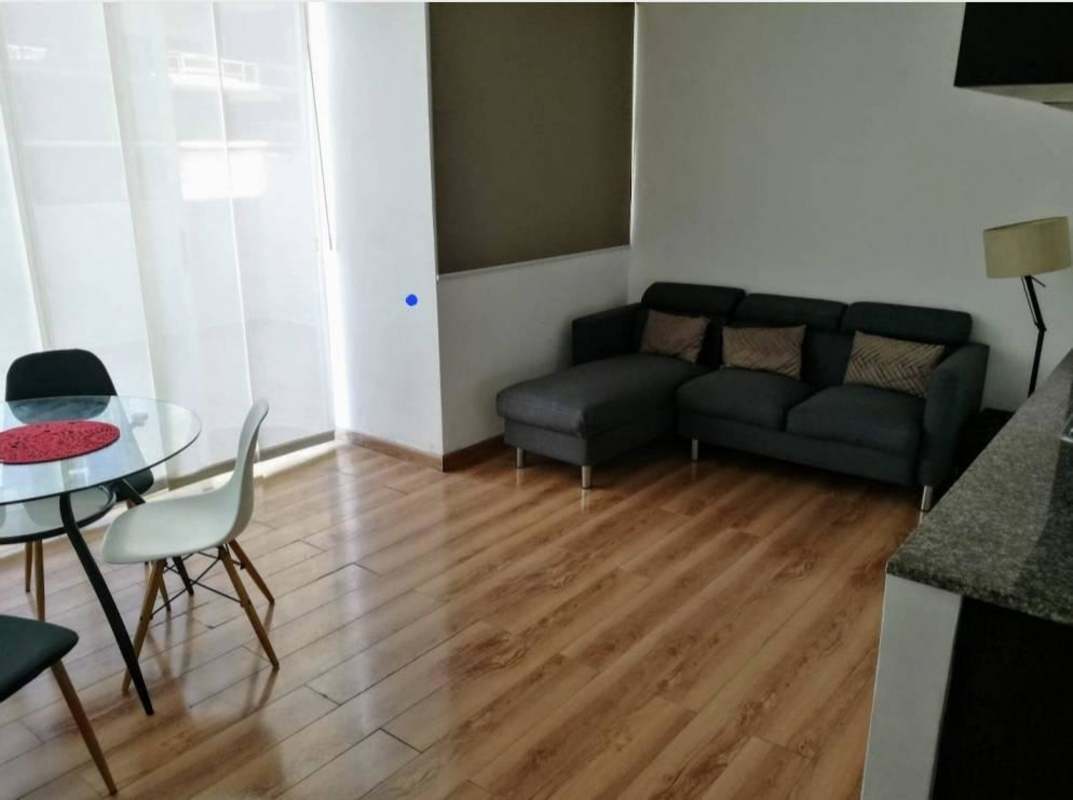 Living and dining with glass table, sofa, wood style flooring in Alsacia Towers Panama rental