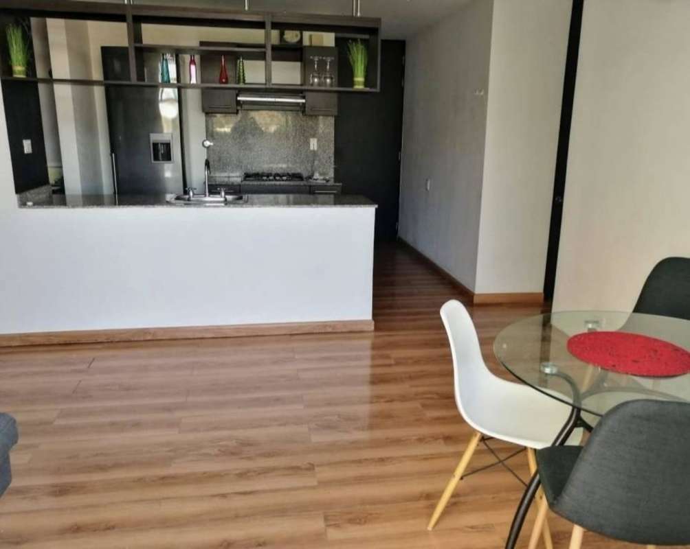 Modern open kitchen with granite counters adjacent to dining area and living space in Alsacia Towers Panama