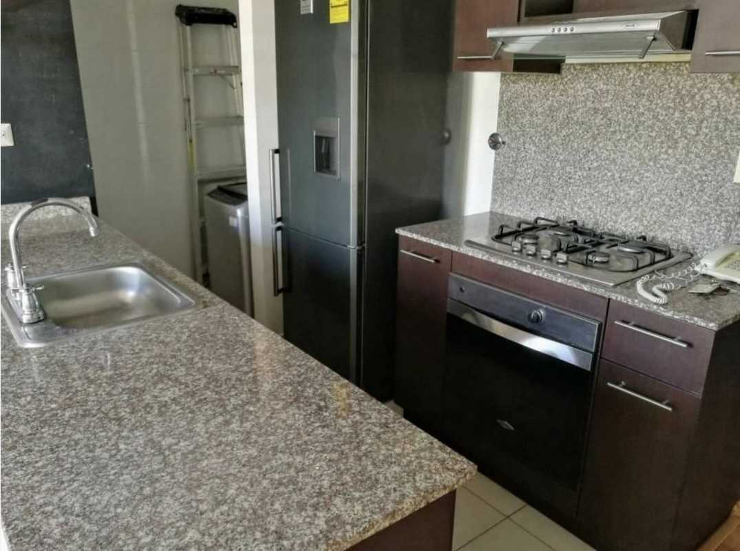 Modern kitchen with granite countertop, stainless appliances PH Alsacia Towers apartment rental