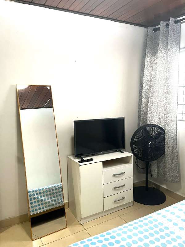 Bedroom corner with TV, mirror, fan and bed rental in Via Brasil Obarrio Panama