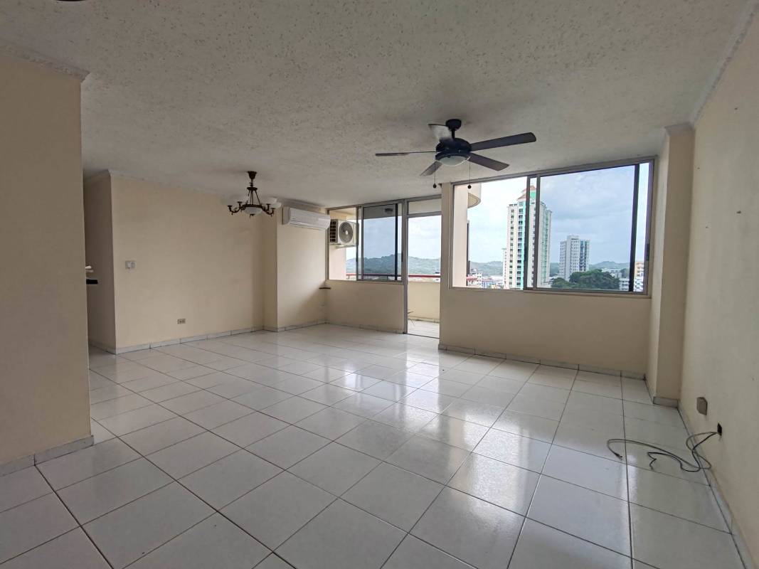 Living room with ceiling fan, AC unit, floor to ceiling windows and balcony in PH Del Caribe El Cangrejo Panama City