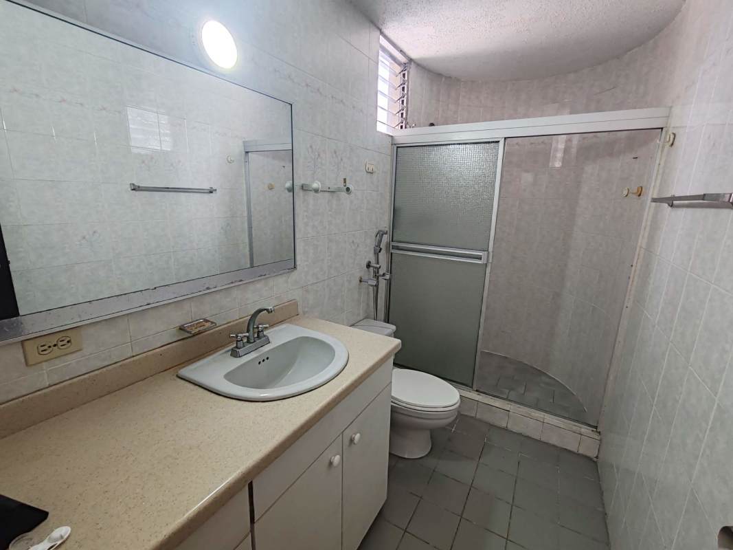Traditional tiled bathroom with enclosed shower glass doors and vanity PH Del Caribe El Cangrejo Panama