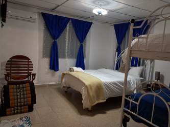 Dining area with table, chairs connected to beach cabin kitchen Panama Malibu Gorgona