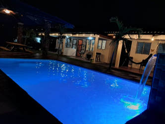 Bedroom with AC, double bed, bunk beds, TV at Malibu Cabins Gorgona Panama vacation rental