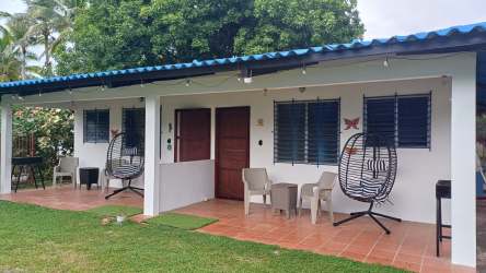 Simple bathroom at Malibu Beach Cabins with shower curtain and tiled walls near Panama City