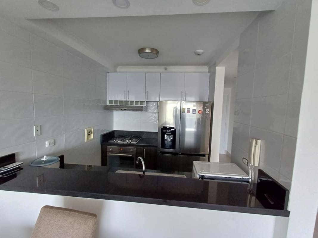 Contemporary compact kitchen with appliances granite top PH Sky Point Panama rental apartment