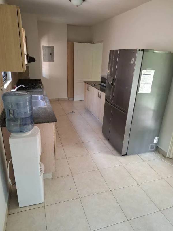 Spacious kitchen with granite countertops, appliances, window lighting in Costa Sur house Panama