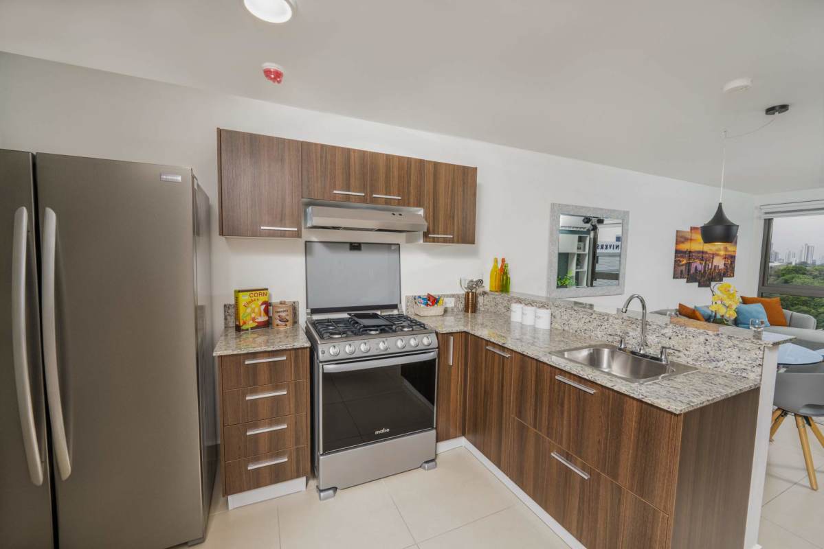 Modern gym with treadmills, weights and large mirrors at PH Spotlight Condos Panama City