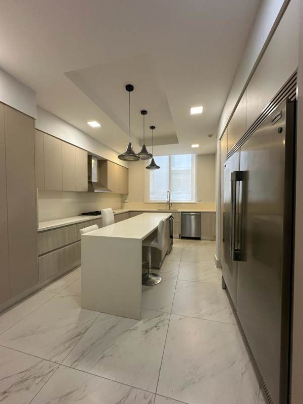 Dining space with glass table, pendant lighting, marble floor in PH Garden Ocean Reef Islands Panama