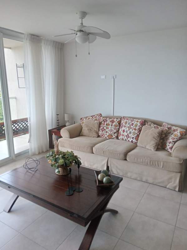 Granite countertops, wood cabinetry, stove, refrigerator in PH Brisas del Golf kitchen Panama City