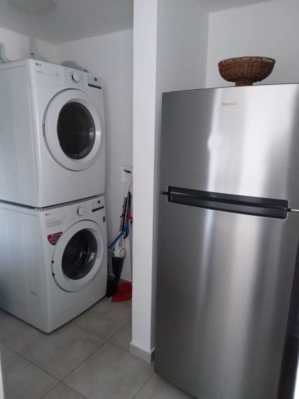 Children's play area with swings, playground next to pool in PH Brisas del Golf Panama City