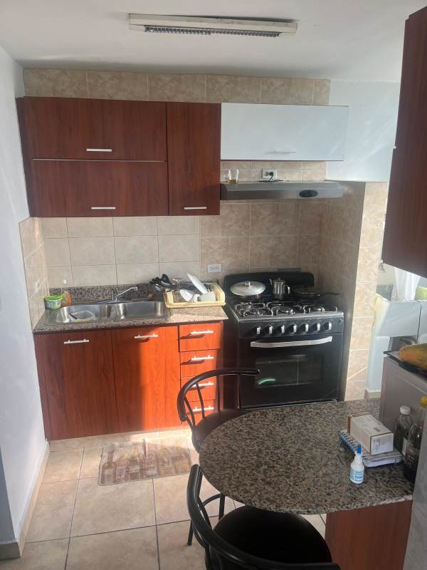 Compact kitchen with granite countertops, double sink, gas stove in PH Green Park Condado del Rey Panama