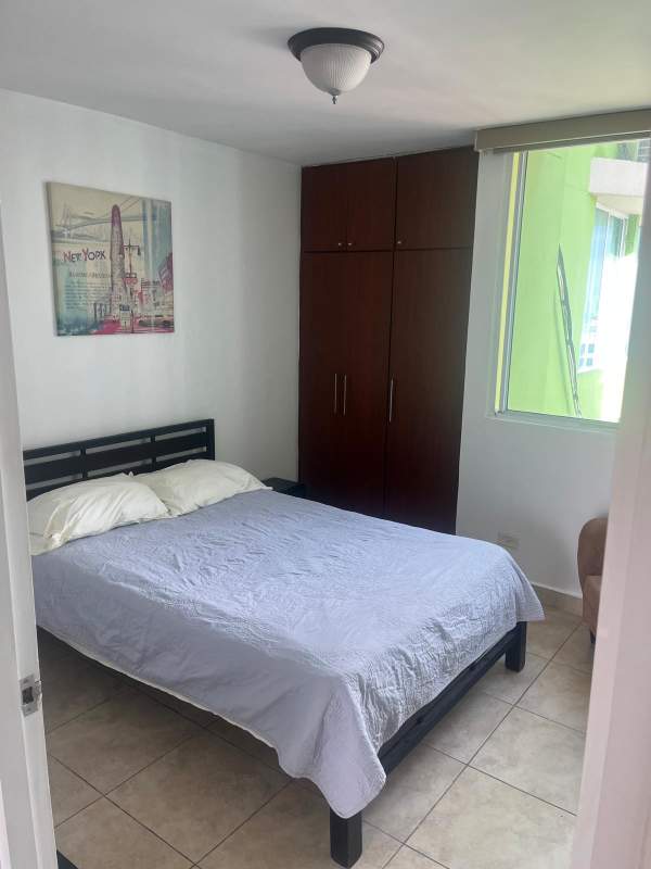 Furnished bedroom with built-in closet, large window and tile floors for rent at PH Green Park Condado del Rey Panama City