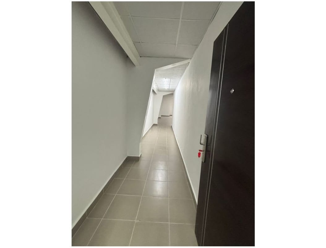 Modern entrance hallway with tiled floor geometric wall and drop ceiling in Centro Comercial Las Mañanitas Panama