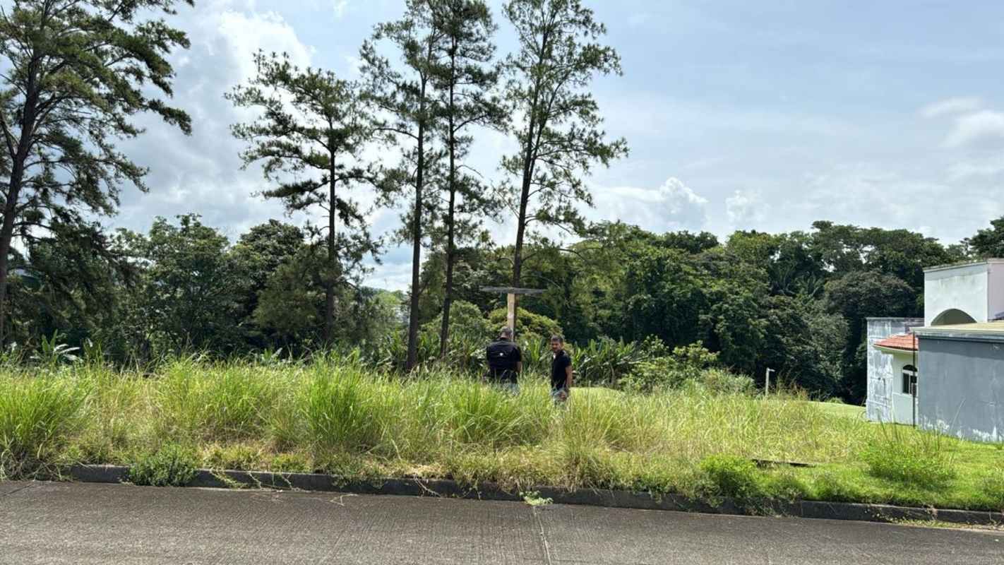 Vacant grassy golf course lot with trees inside private Panama Golf Club