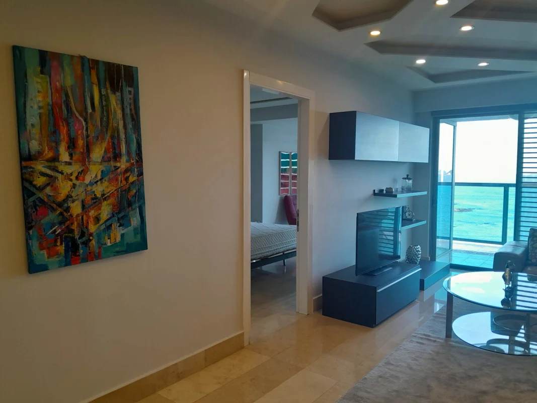 Elegant bedroom with floor-to-ceiling ocean view windows at YOO Panama Panama City