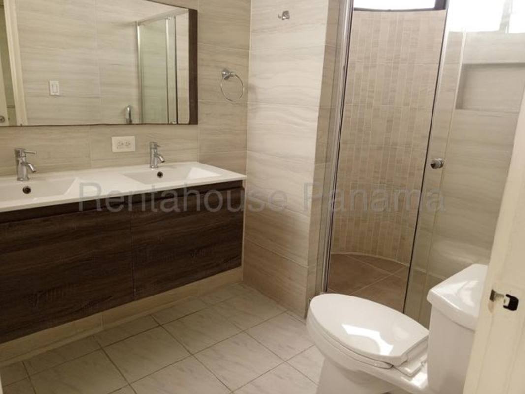 Bathroom with double sink vanity, glass enclosed shower and modern tiles in PH Torres del Pacifico