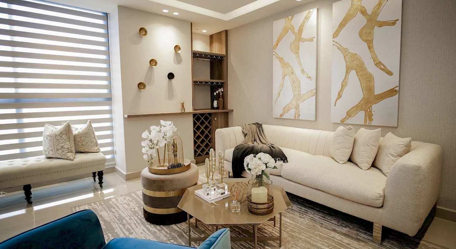 Open concept living room with stylish furniture and bar in Torre 74 Panama City