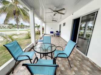 Furnished patio with blue chairs and garden view at PH Ibiza Beach San Carlos Panama